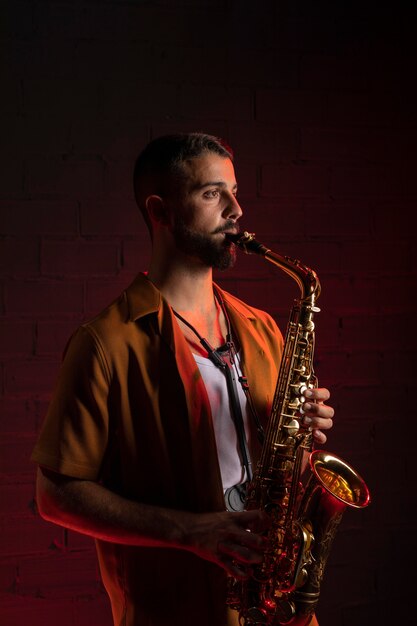 Side view of male musician playing the saxophone