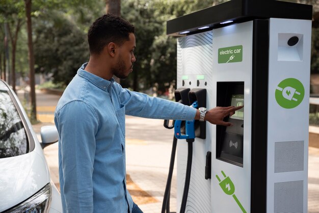 Side view man charging electric car