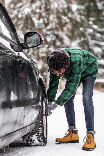 Side view man checking car