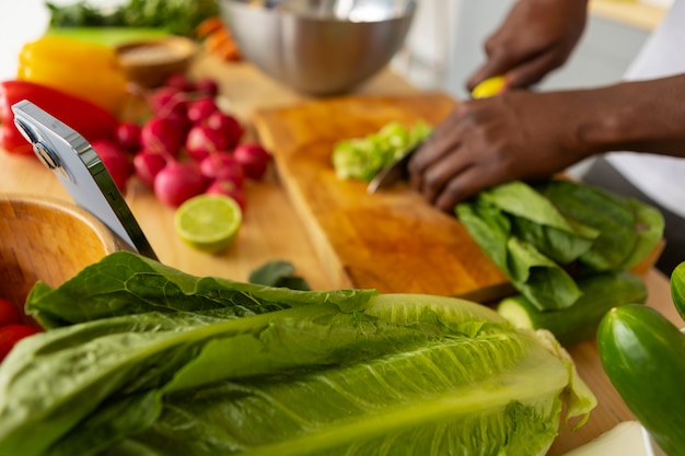 Side view man cooking with smartphone