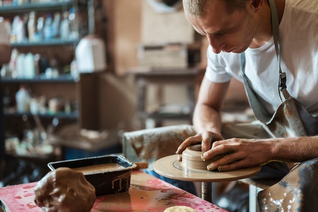 Free Photo side view man doing pottery