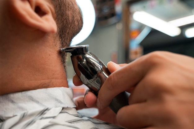 Side view man getting groomed