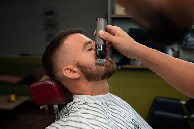 Side view man getting groomed