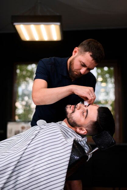 Side view of man getting a haircut