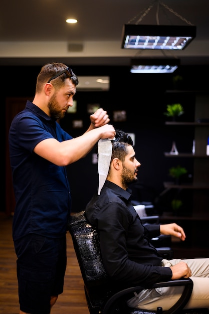 Side view of man getting a new haircut