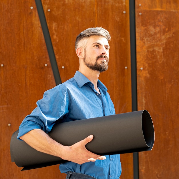 Side view of man holding building plan