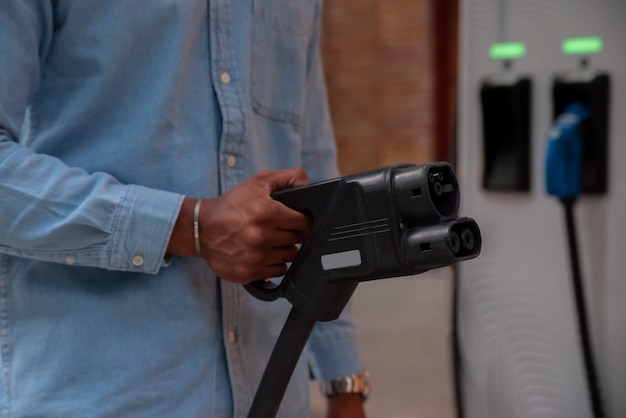 Side view man holding car charger