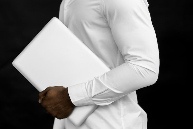 Side view man holding  laptop