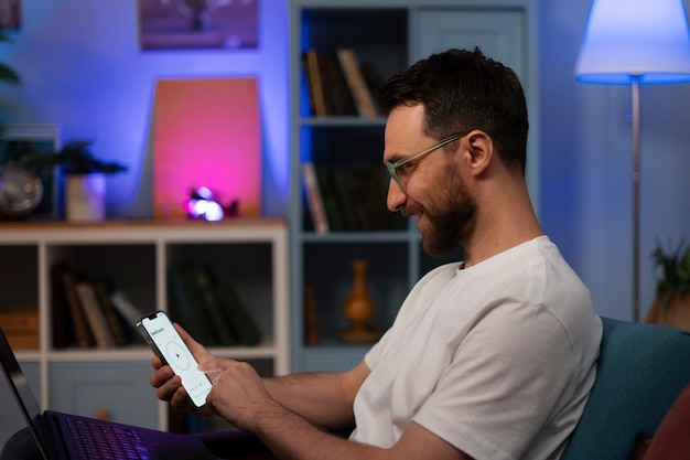 Side view man holding smartphone