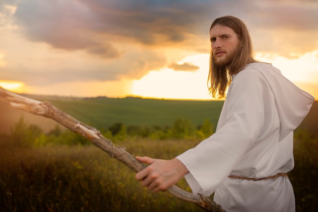 Free Photo side view man holding stick