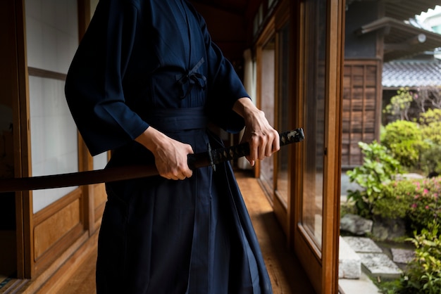 Free Photo side view man holding sword