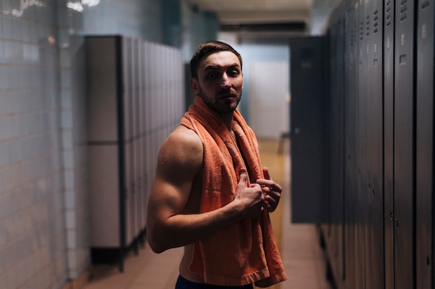 Free photo side view man at locker room after swimming