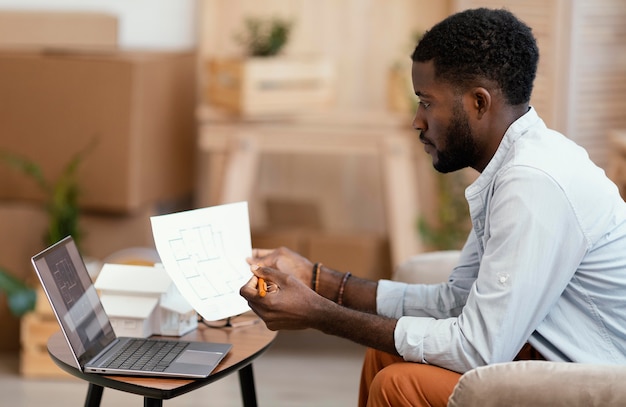 Side view of man making plans to redecorate house