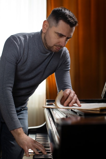 Side view man playing piano