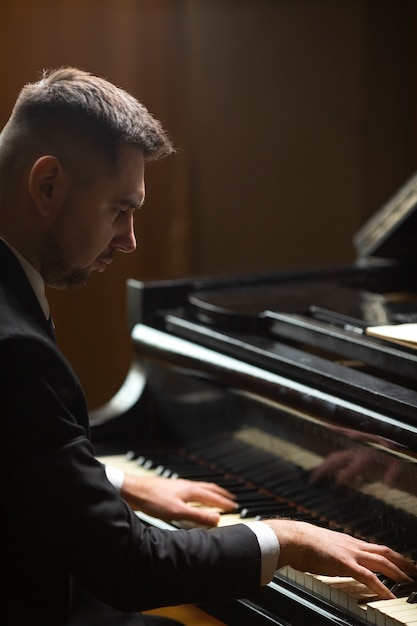 Side view man playing piano