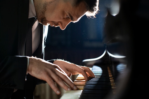 Side view man playing piano