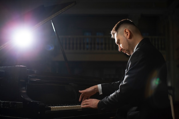 Side view man playing piano