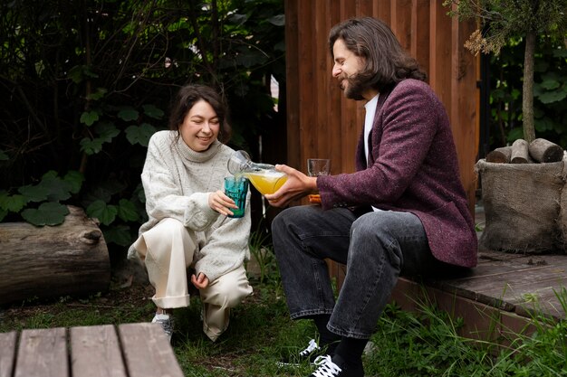 Side view man pouring drink for smiley woman