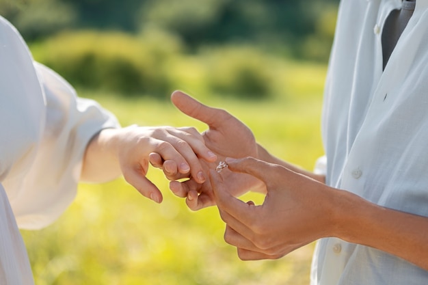 Side view man putting ring on finger