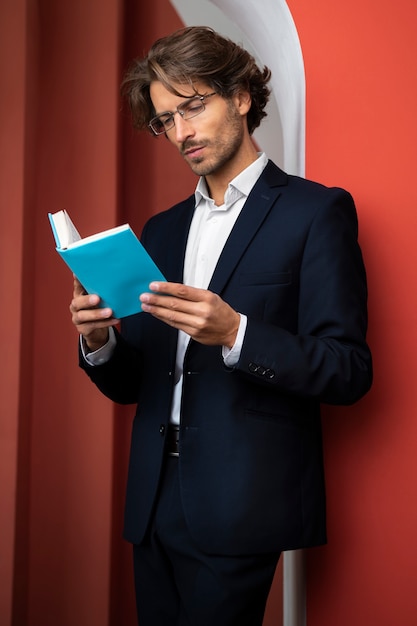 Side view man reading book indoors