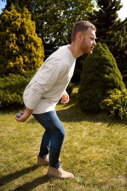 Free photo side view man ready to throw ball