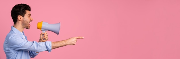 Free Photo side view of man shouting in megaphone with copy space