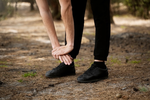 Side view man stretching in nature