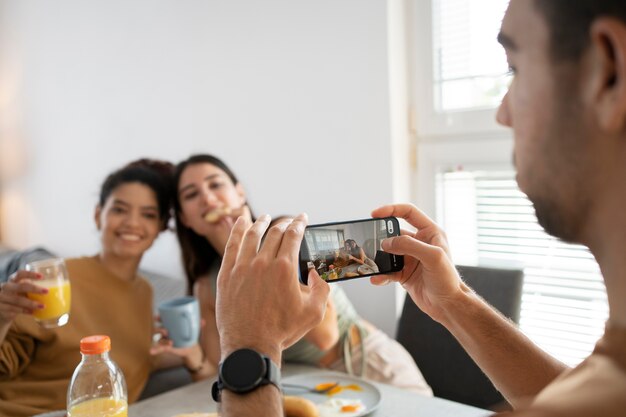 Side view man taking photos with smartphone