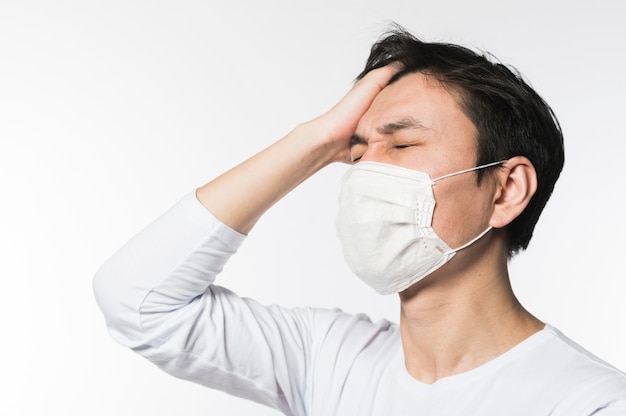 Side view of man touching his head in sickness