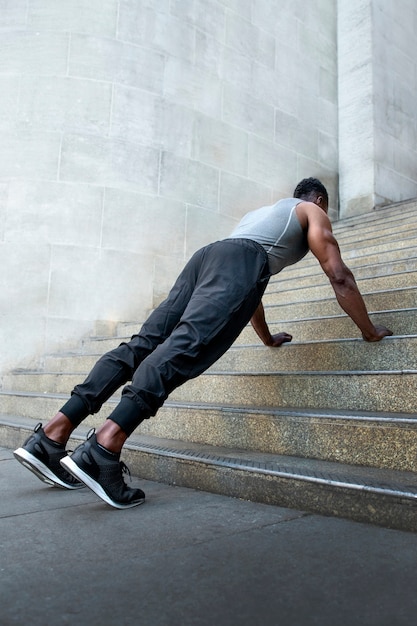 Free photo side view man training with stairs