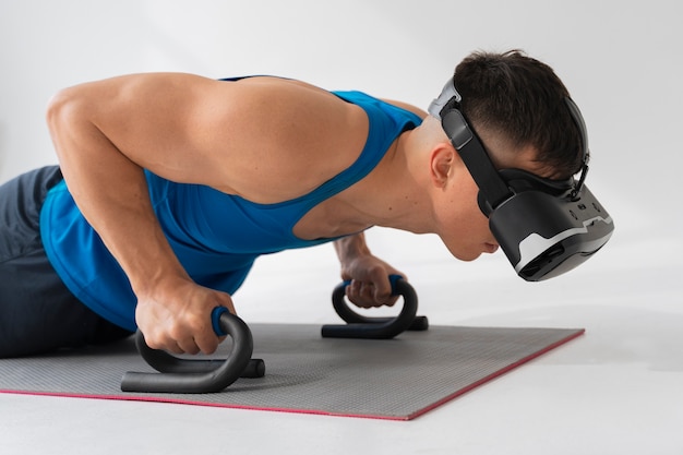 Side view man training with vr glasses on