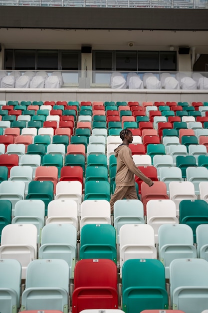 Free photo side view man walking between rows