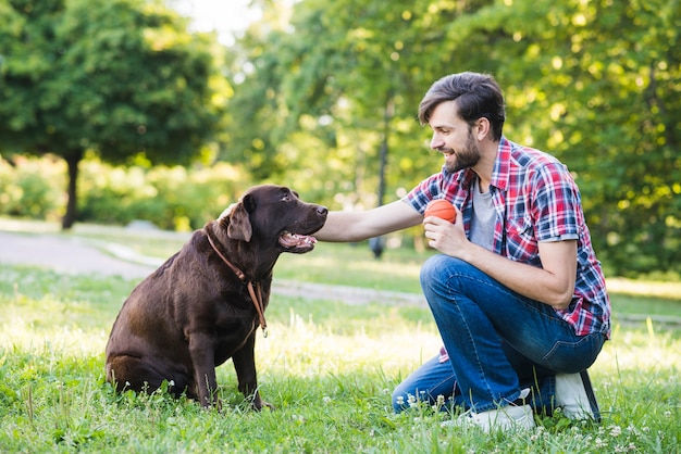 Side view of a man with his dog on grass