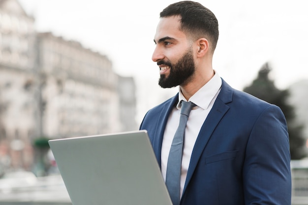 Side view man with laptop