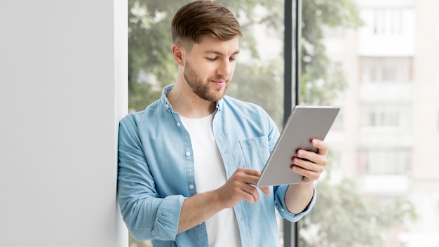 Side view man with tablet