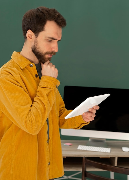 Side view man with tablet