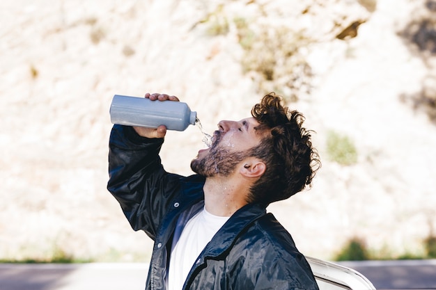 Side view of man with water bottle