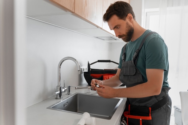 Side view man working as plumber