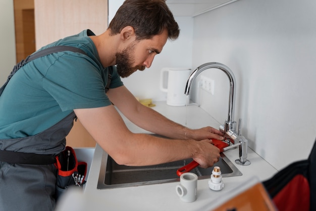 Free Photo side view man working as plumber