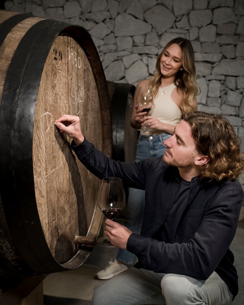 Free Photo side view man writing on barrel