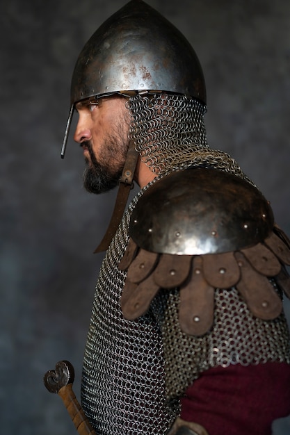 Side view medieval soldier posing in studio