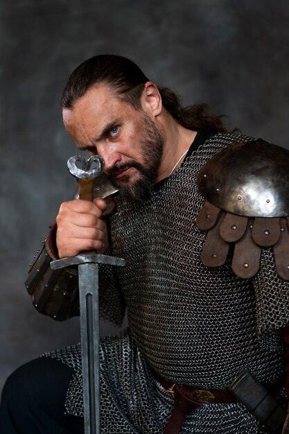 Side view medieval soldier posing in studio