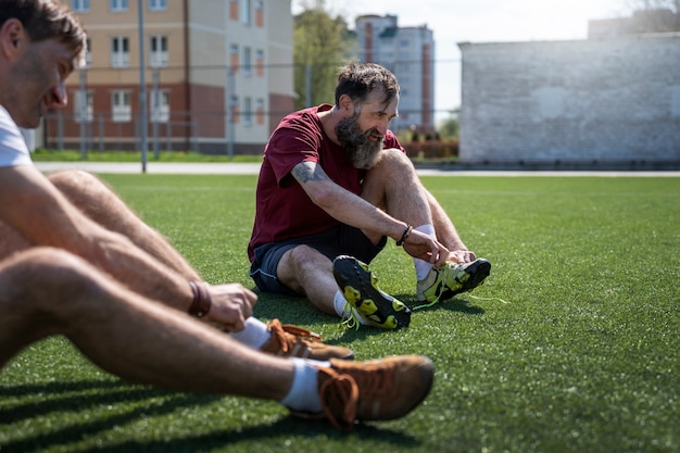 Free Photo side view men on soccer field