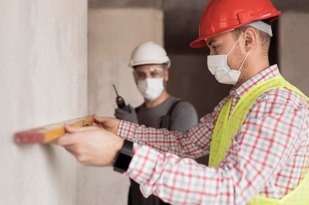 Free Photo side view men working with masks