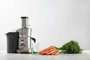 Free photo side view metallic professional juicer with empty glass is prepa