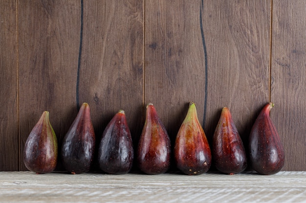 Side view mission figs on wooden table. horizontal space for text