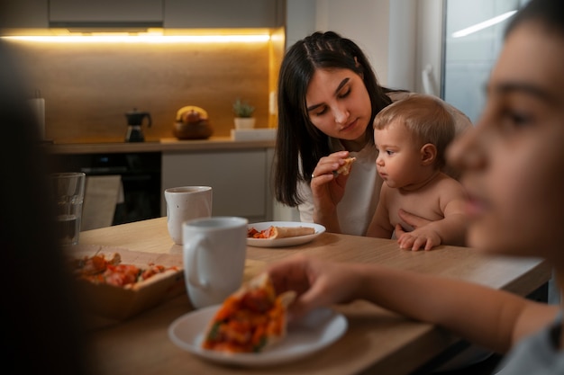 Side view mother and baby with food