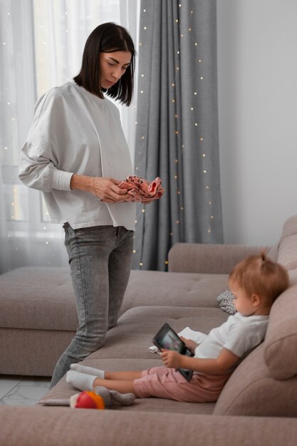 Side view mother holding clothes