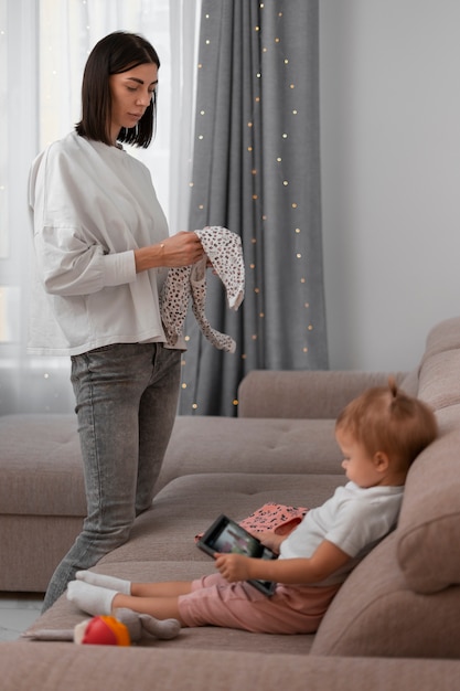 Side view mother holding clothes