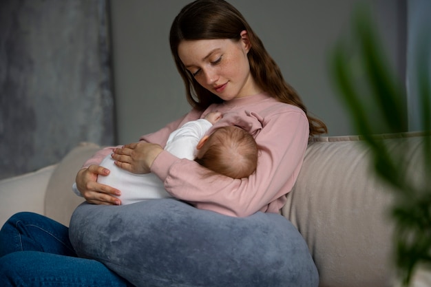 Side view mother with cute newborn